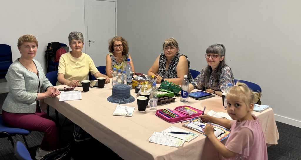 Dina Railean, Honorary Consul of the Republic of Moldova in Manchester and CEO of Moldovan Diaspora Business Alliance Ltd, together with members of the MDBA Book Club during a literary discussion held on 21 June 2026 in Manchester. Participants from the Moldovan and Romanian diasporas gather around a table to discuss the book "20 de ani în Siberia" by Anita Nandriș-Cudla, promoting Romanian-language literature, cultural heritage, friendship and community engagement. The event, sponsored by Express Language Solutions Ltd and hosted by Family Shop Moldova, encourages reading, preserves the Romanian language and culture, strengthens social connections within the diaspora and creates opportunities for networking, exchanging ideas and supporting the Moldovan community in the United Kingdom.